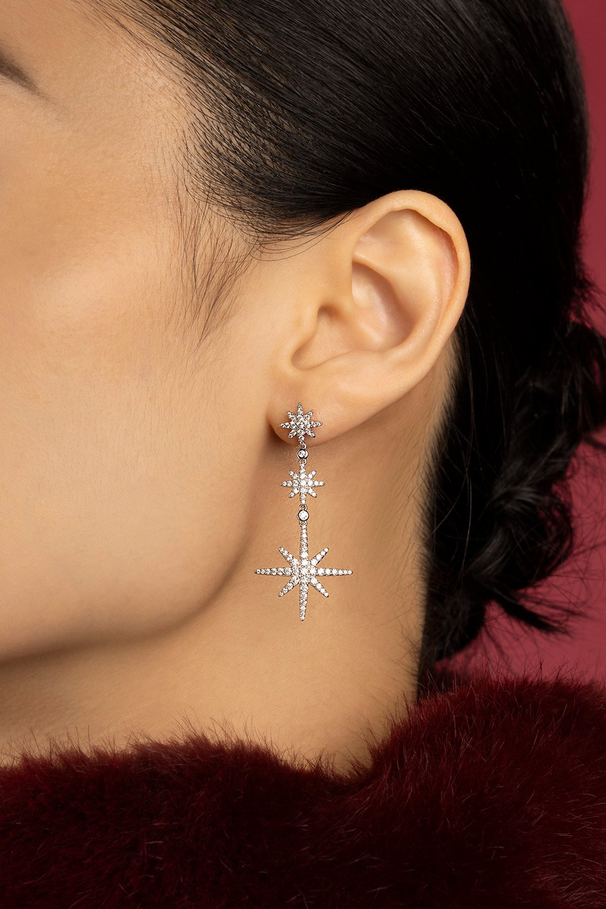 Woman wearing APM Météorites earrings, a cascade of stars lighting the night.