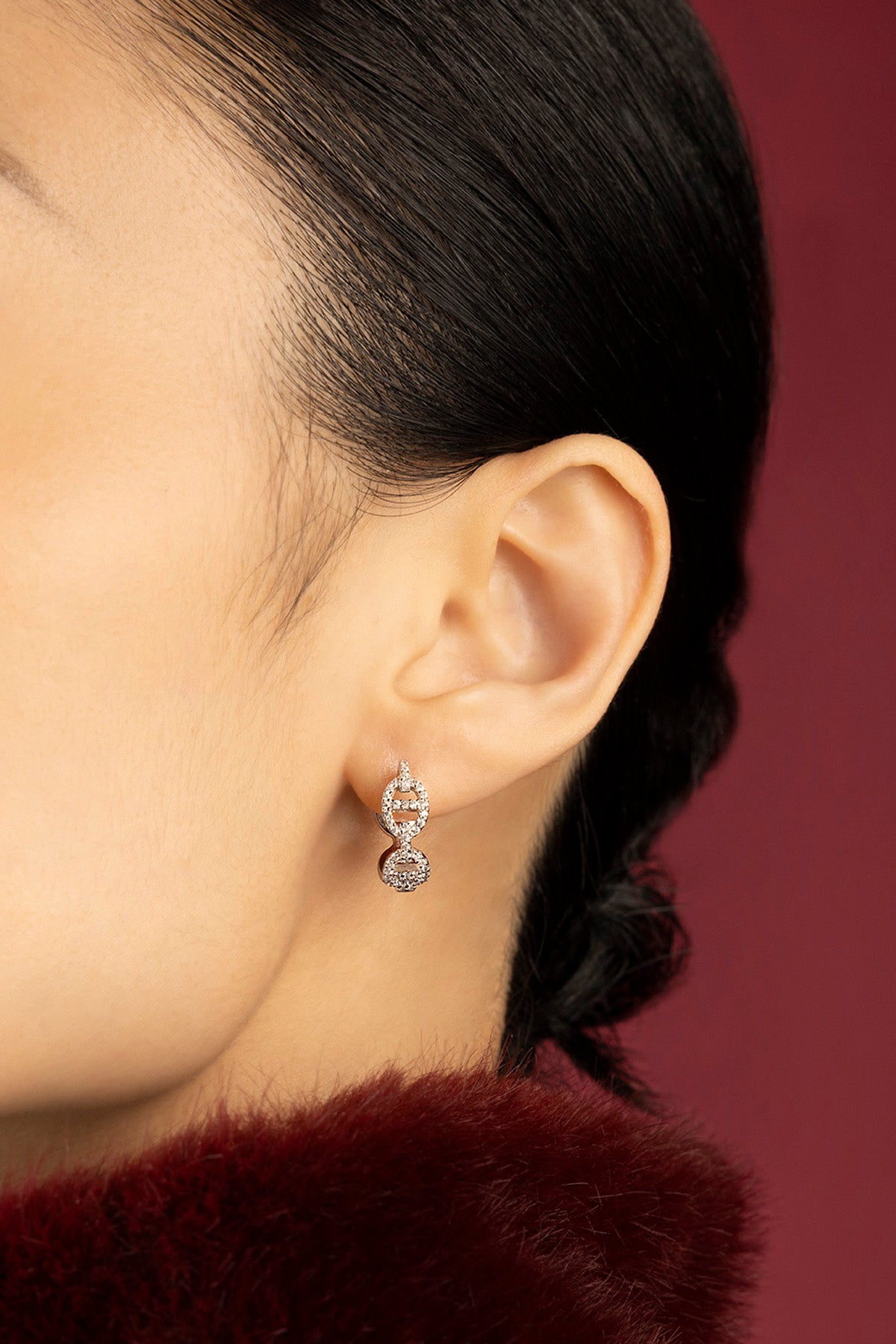 Woman wearing APM Morse Earrings, a shimmering whisper of modern elegance.