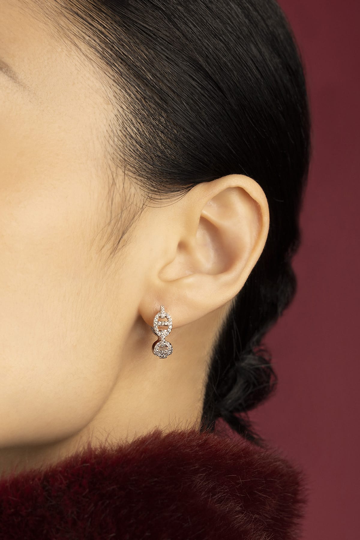 Woman wearing APM Morse Earrings, a shimmering whisper of modern elegance.