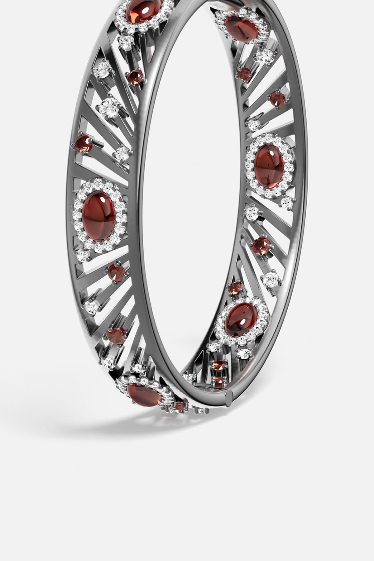APM Bangle in rhodium finish, radiant with deep red stones and crystalline sparkle.