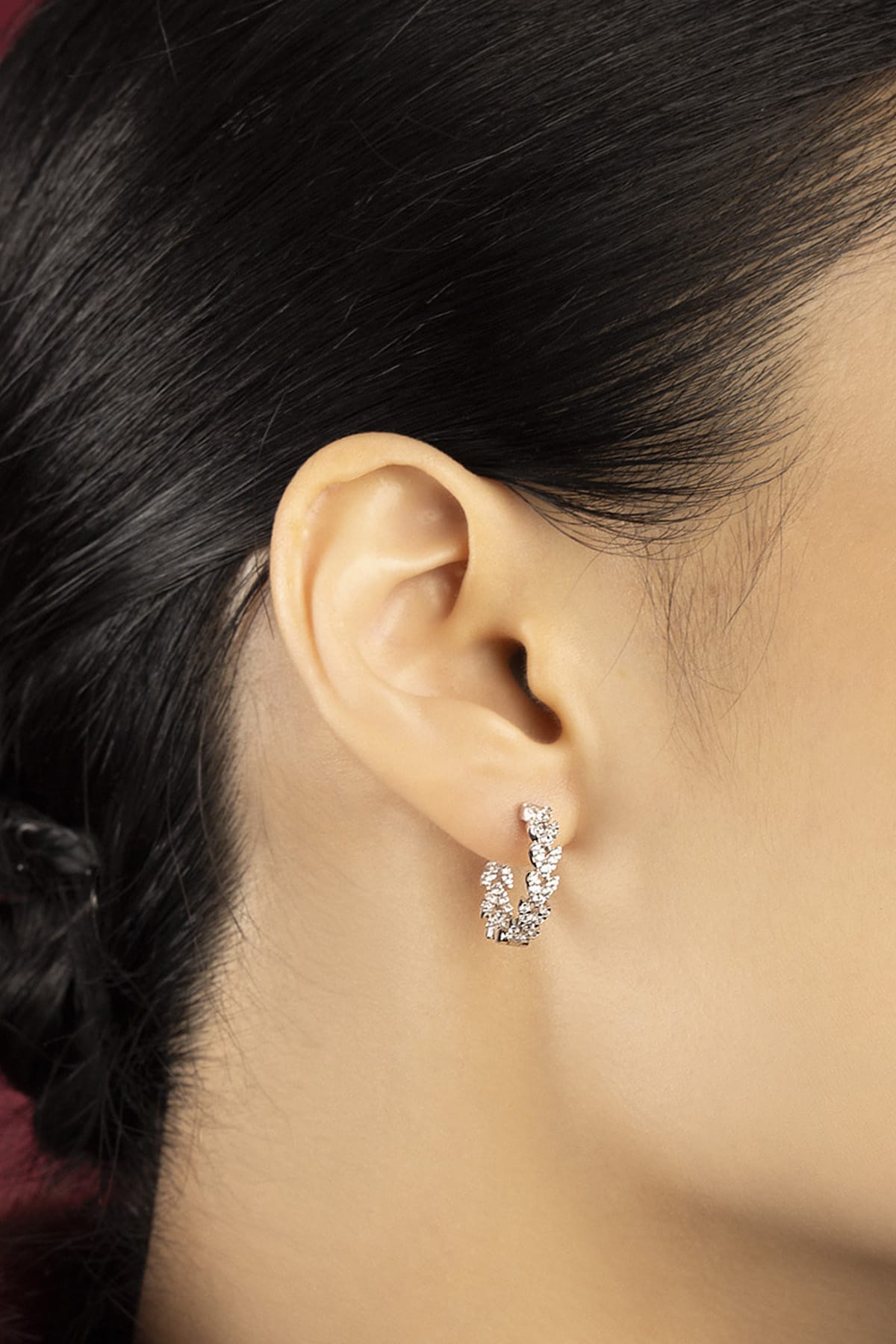 Woman wearing APM Hoop Earrings, a delicate sparkle of effortless modern elegance.