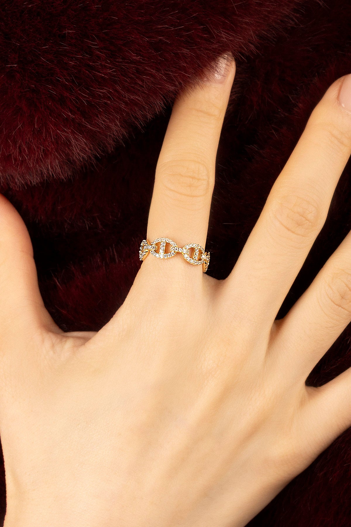 Woman wearing APM Morse Ring, a golden whisper of linked elegance.