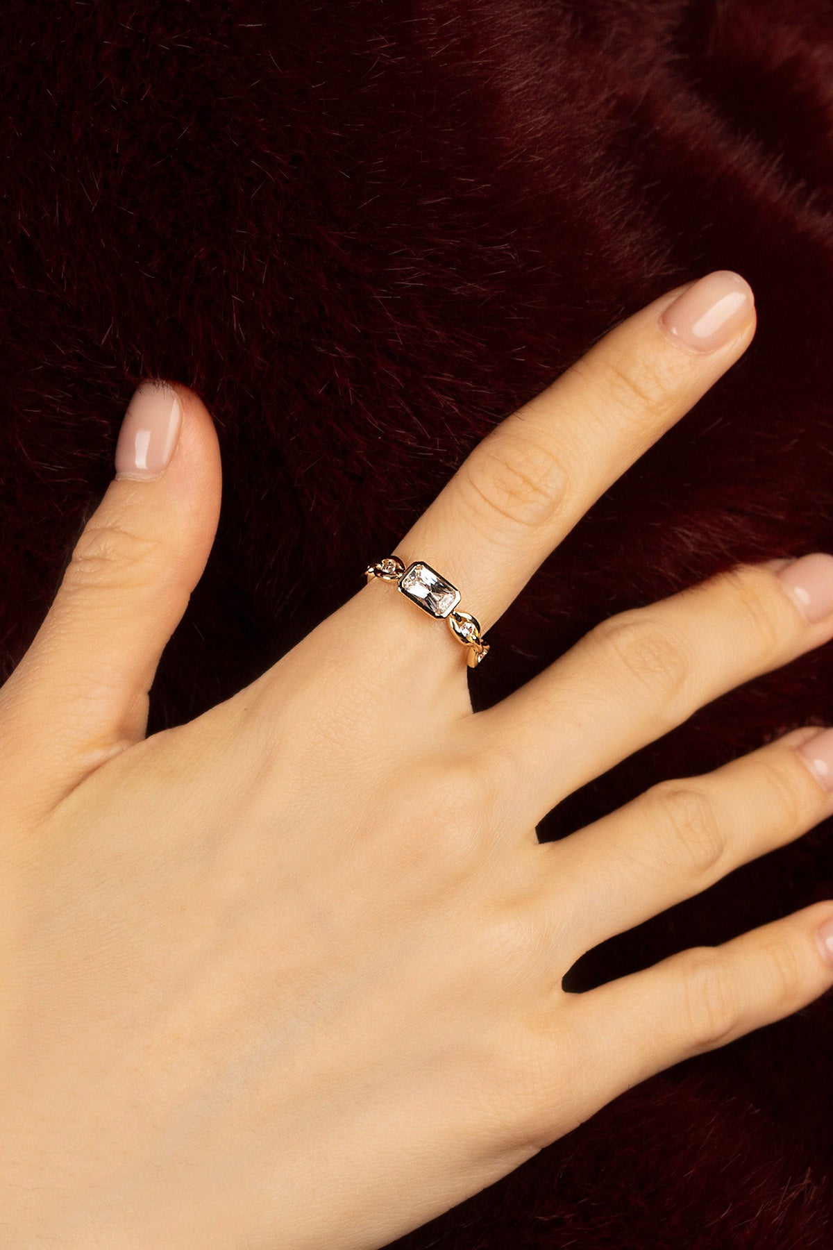 Woman wearing APM ring, a golden whisper of quiet elegance.