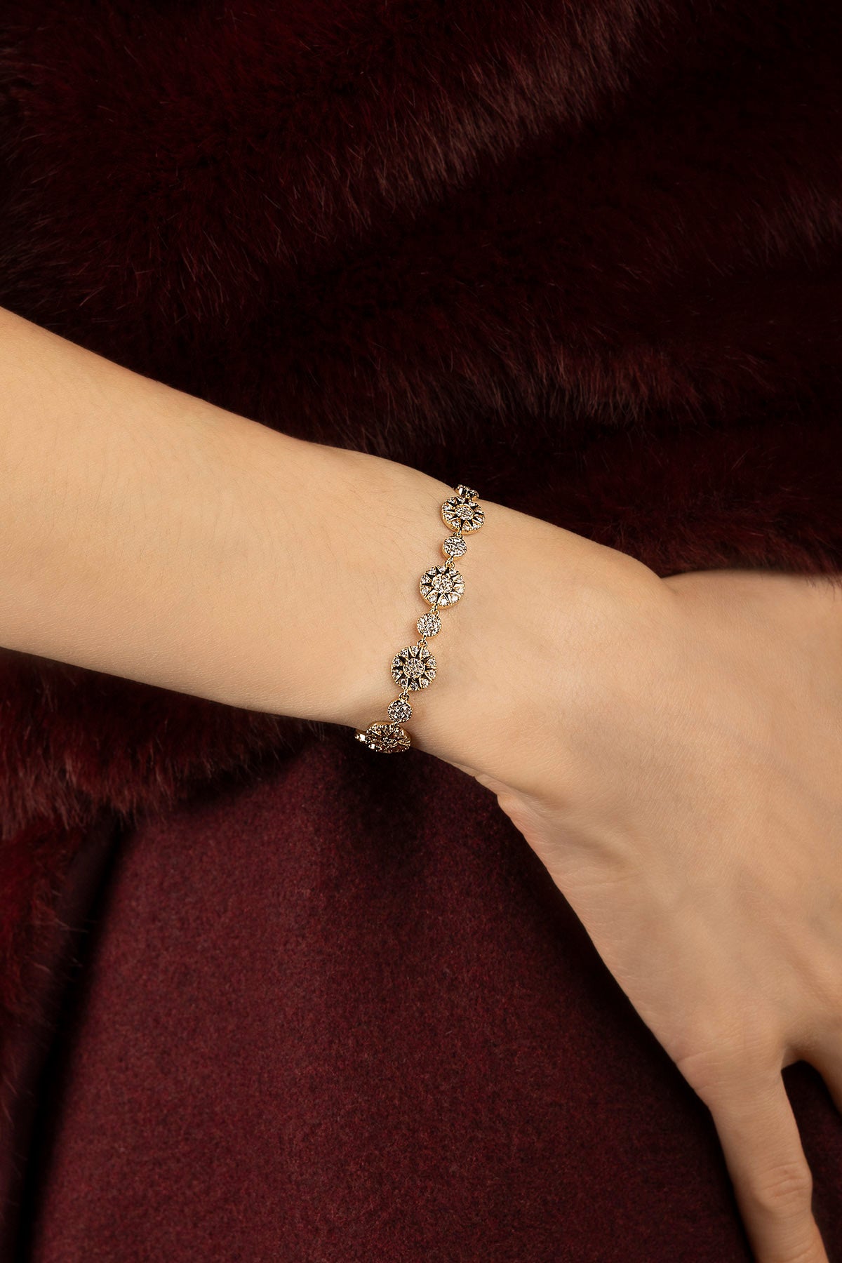 Woman wearing APM Morse Bracelet, a golden whisper of celestial charm.