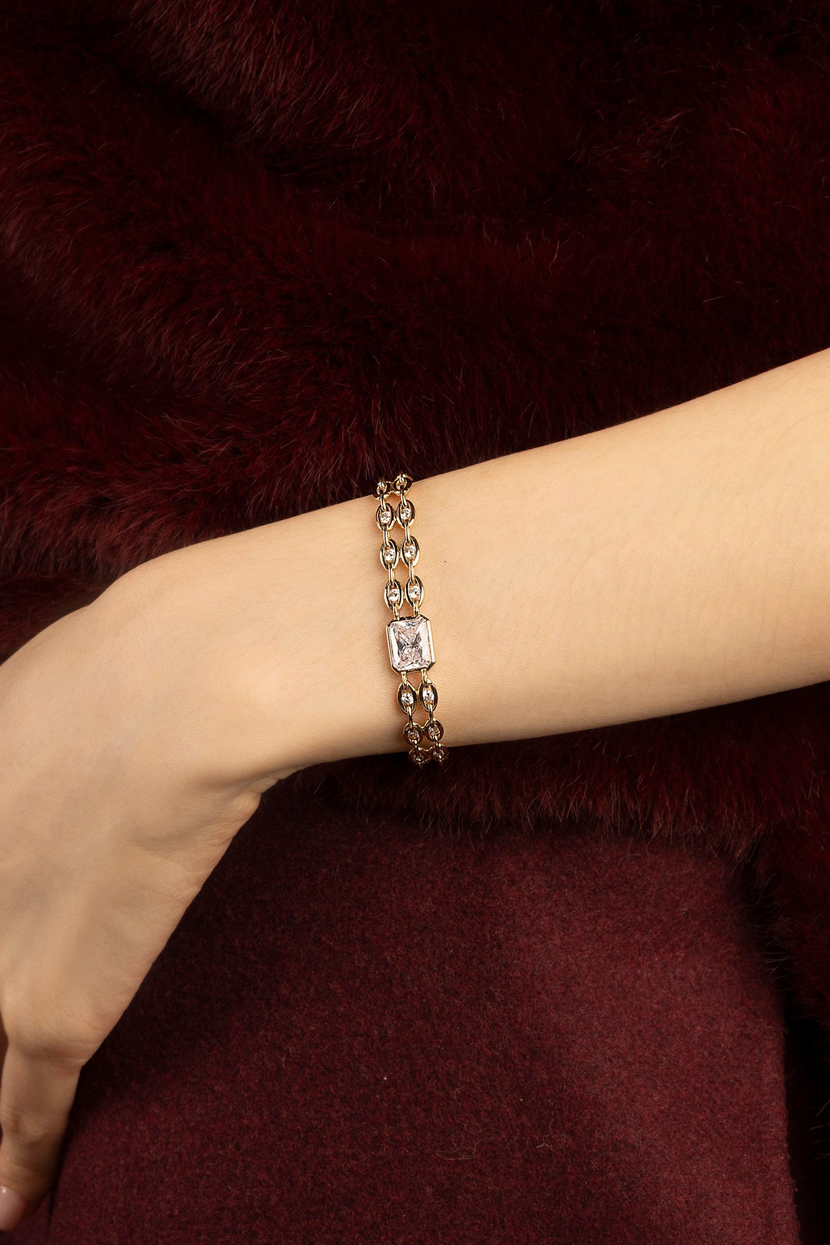 Woman wearing APM Monaco bracelet, a golden whisper of refined elegance.