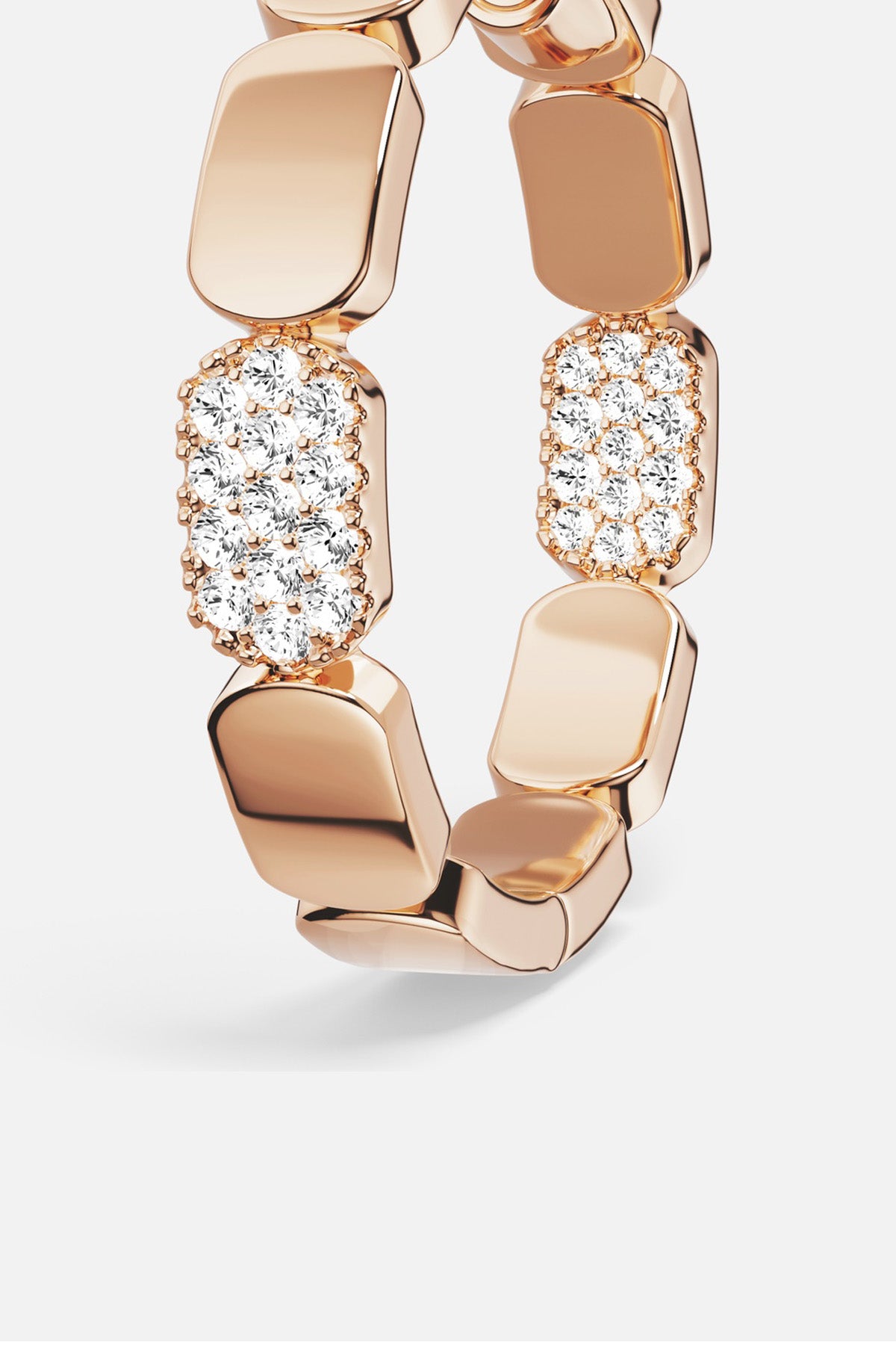 APM Ring in warm rose color, sculpted links meeting a shimmer of pavé brilliance.