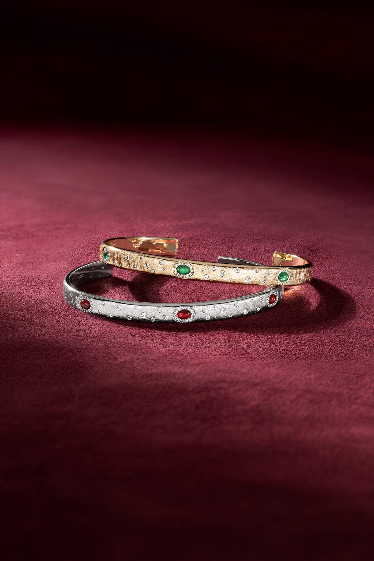 APM Monaco cuff bracelets in gold and rhodium finish, jewel-lit with quiet allure.