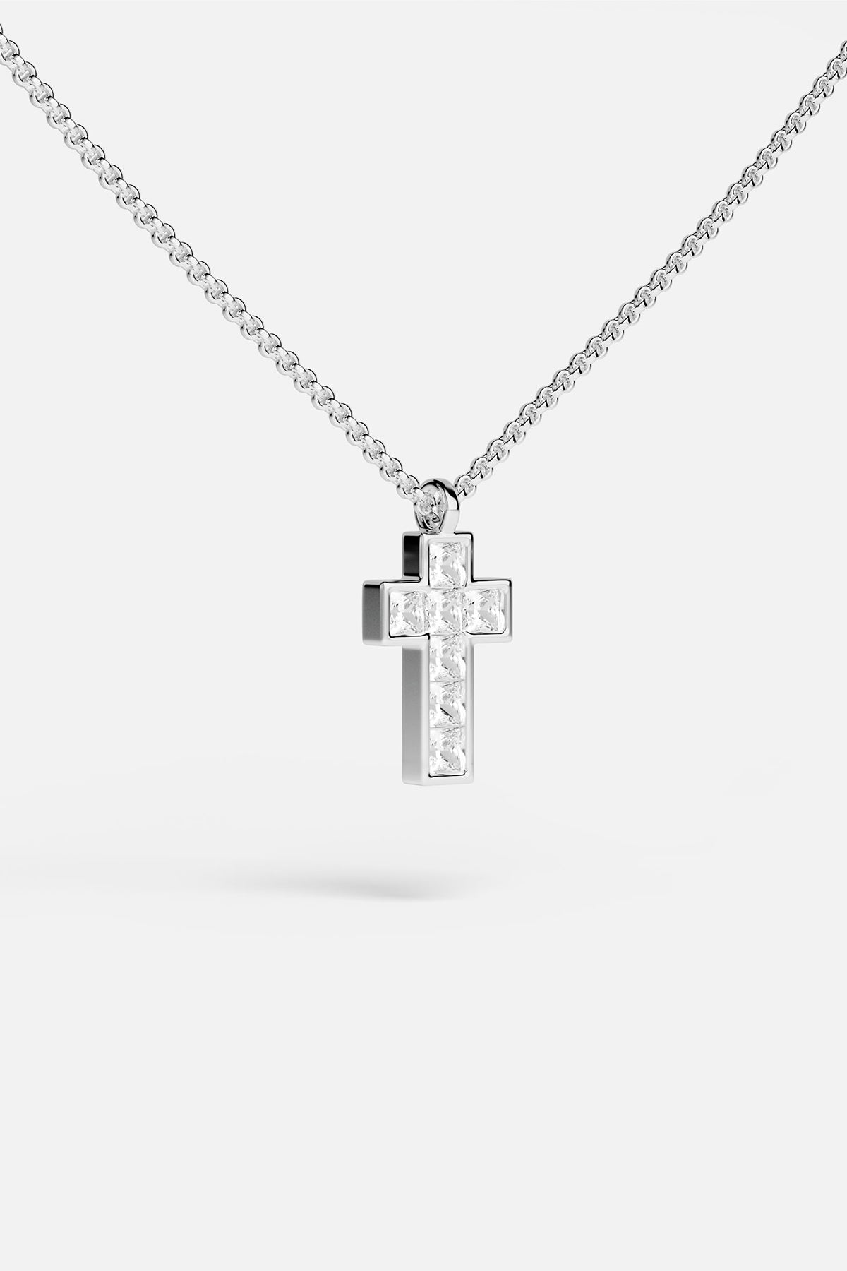 APM Cross Necklace, a luminous emblem in rhodium finish, quietly radiant.