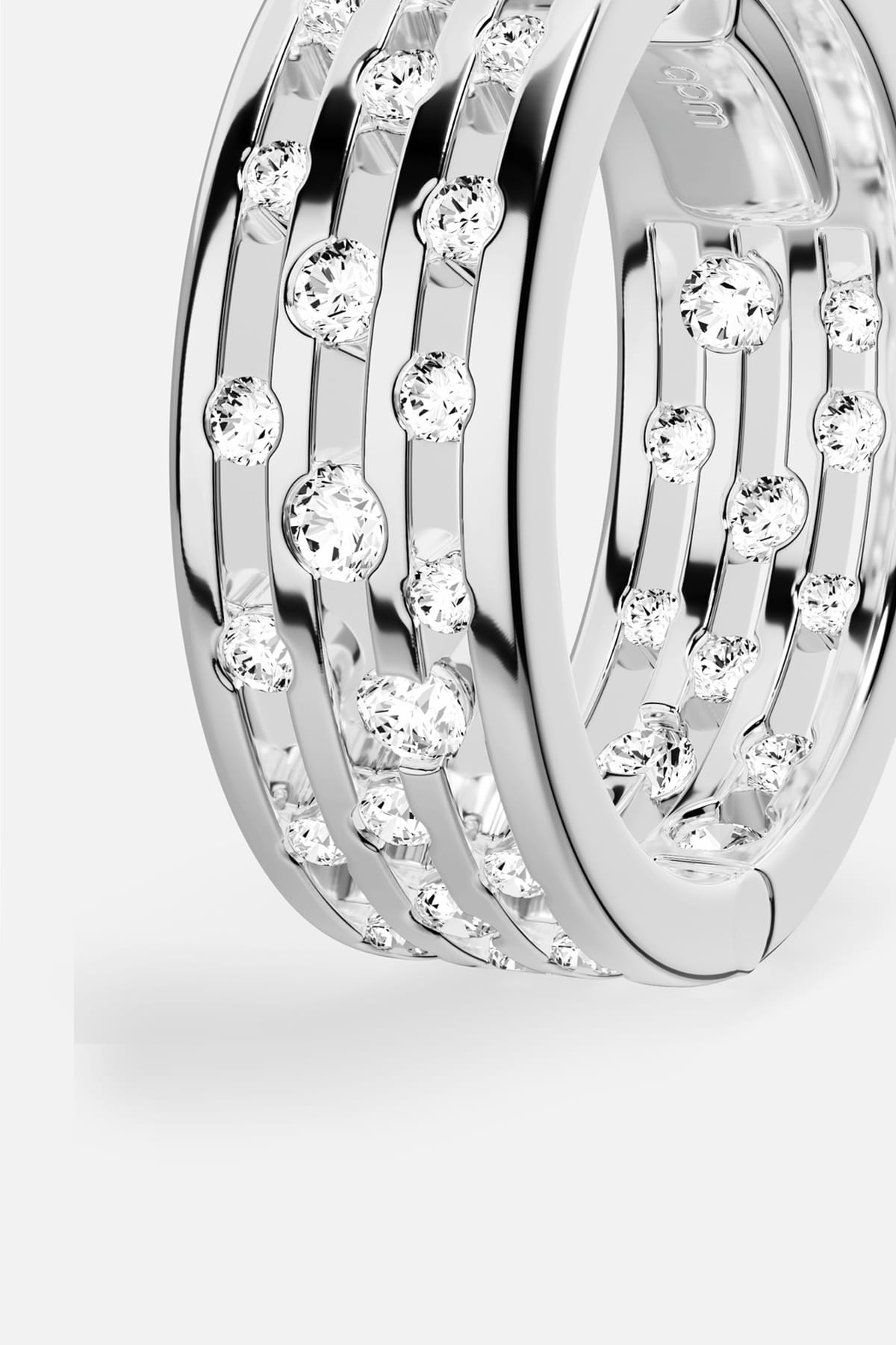 APM Ring in rhodium finish, scattered stones dancing with quiet, modern brilliance.