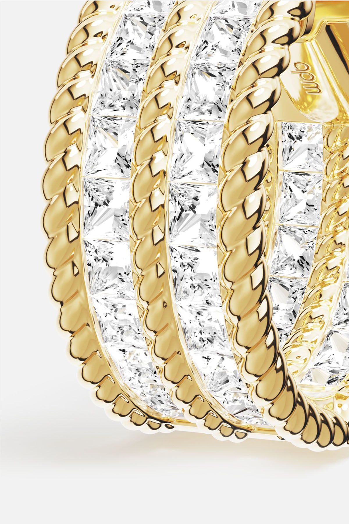 APM Ring in golden color, twisted rope lines and radiant stones, quietly luminous.