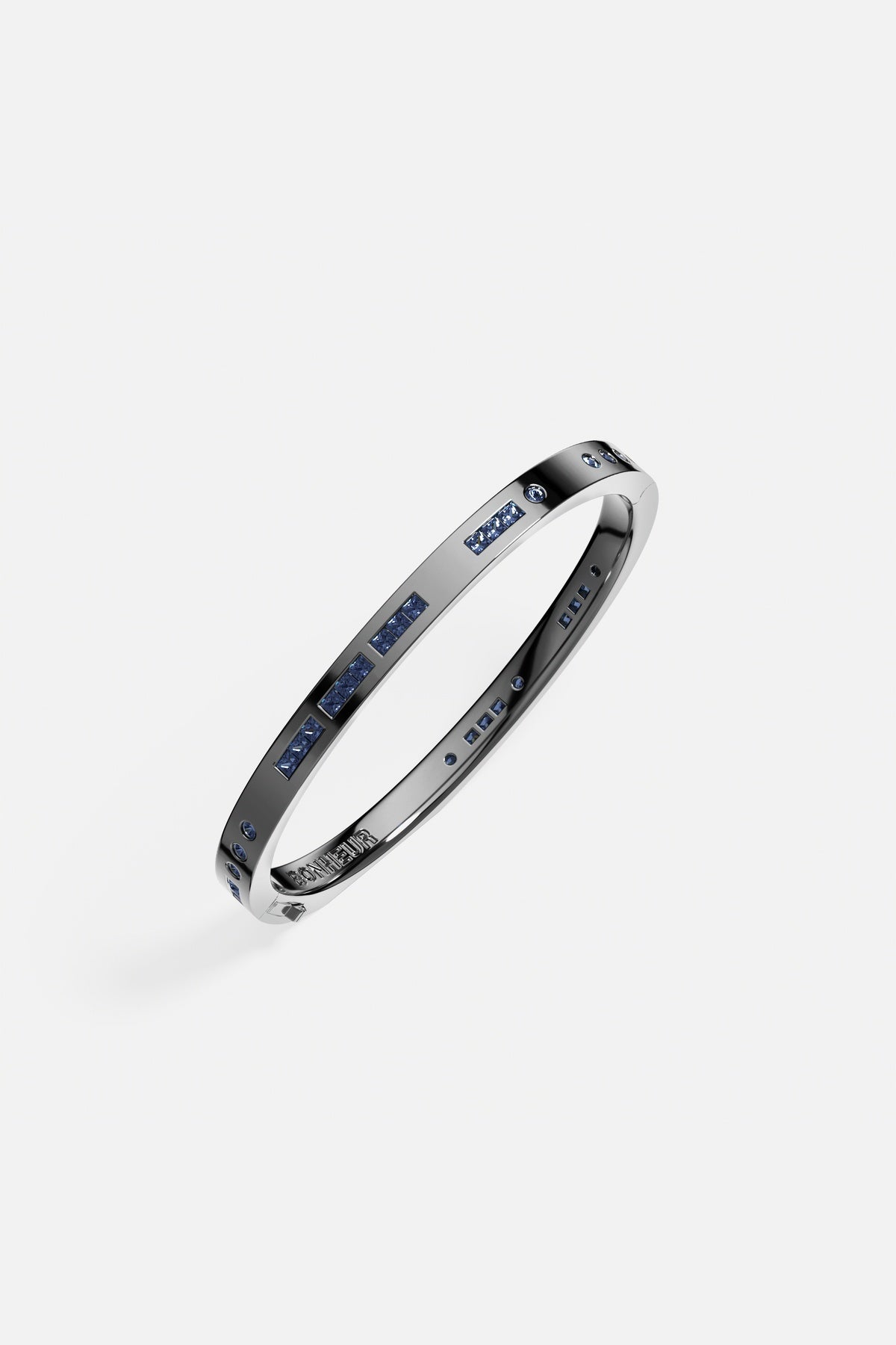 APM Bangle in rhodium finish, midnight blue stones whispering quiet modern elegance.