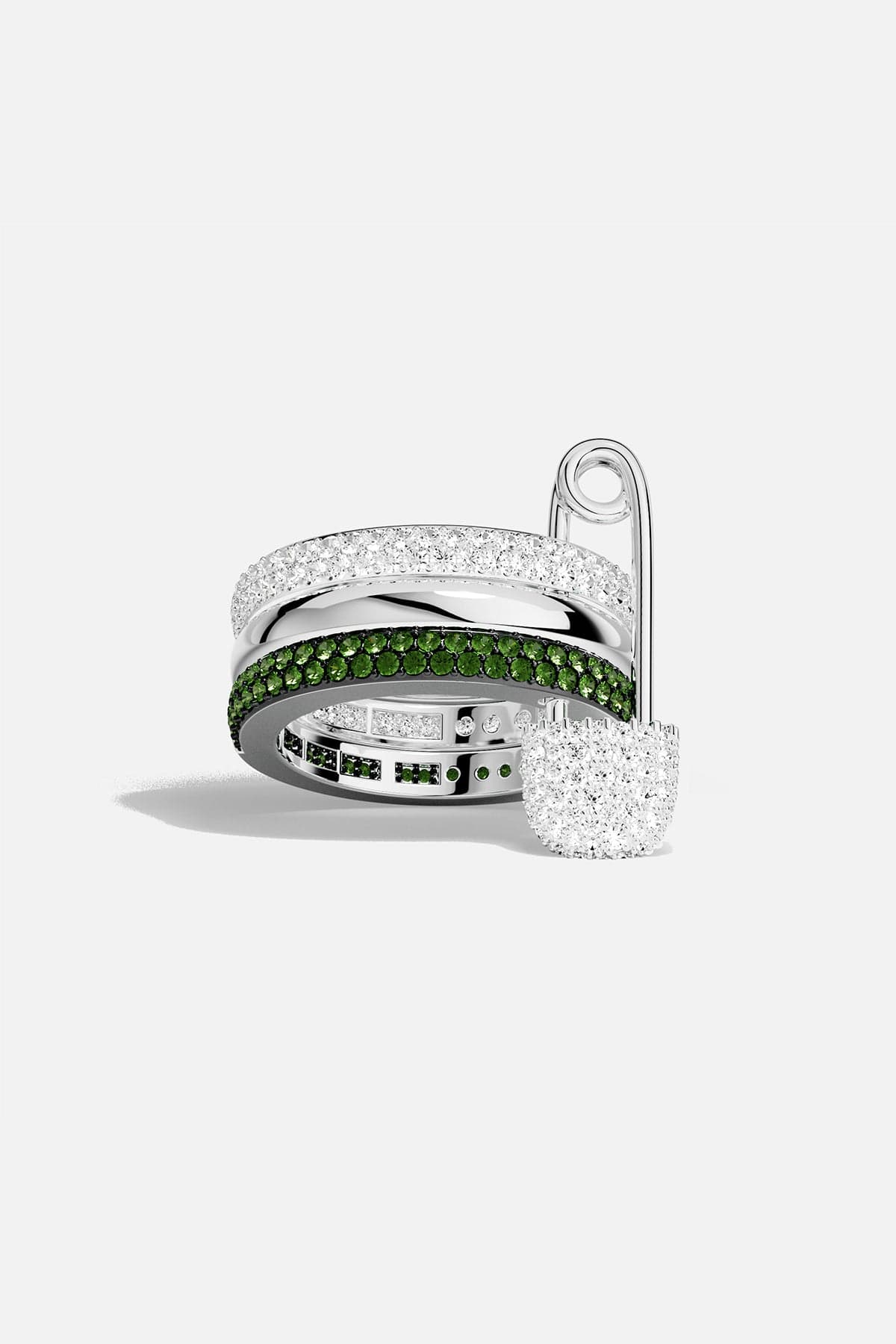 APM MONACO Silver ring with a silver pin and green stones on a white background