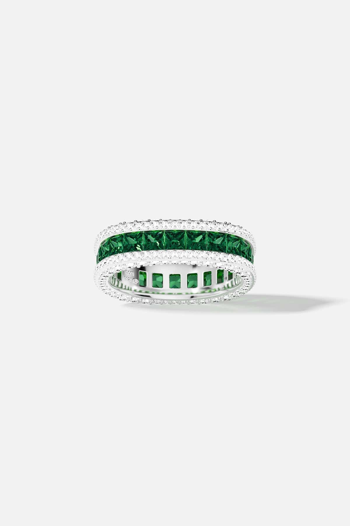 Silver ring with green and white stones on a white background