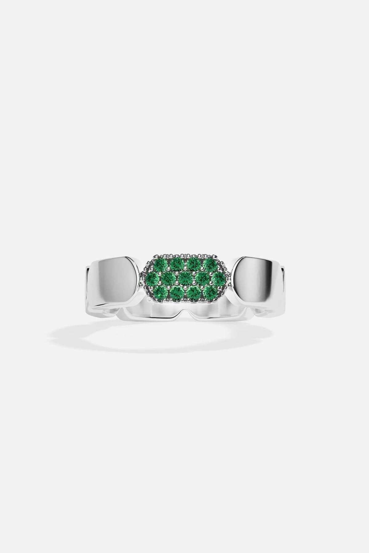 Silver ring with green stones on a white background