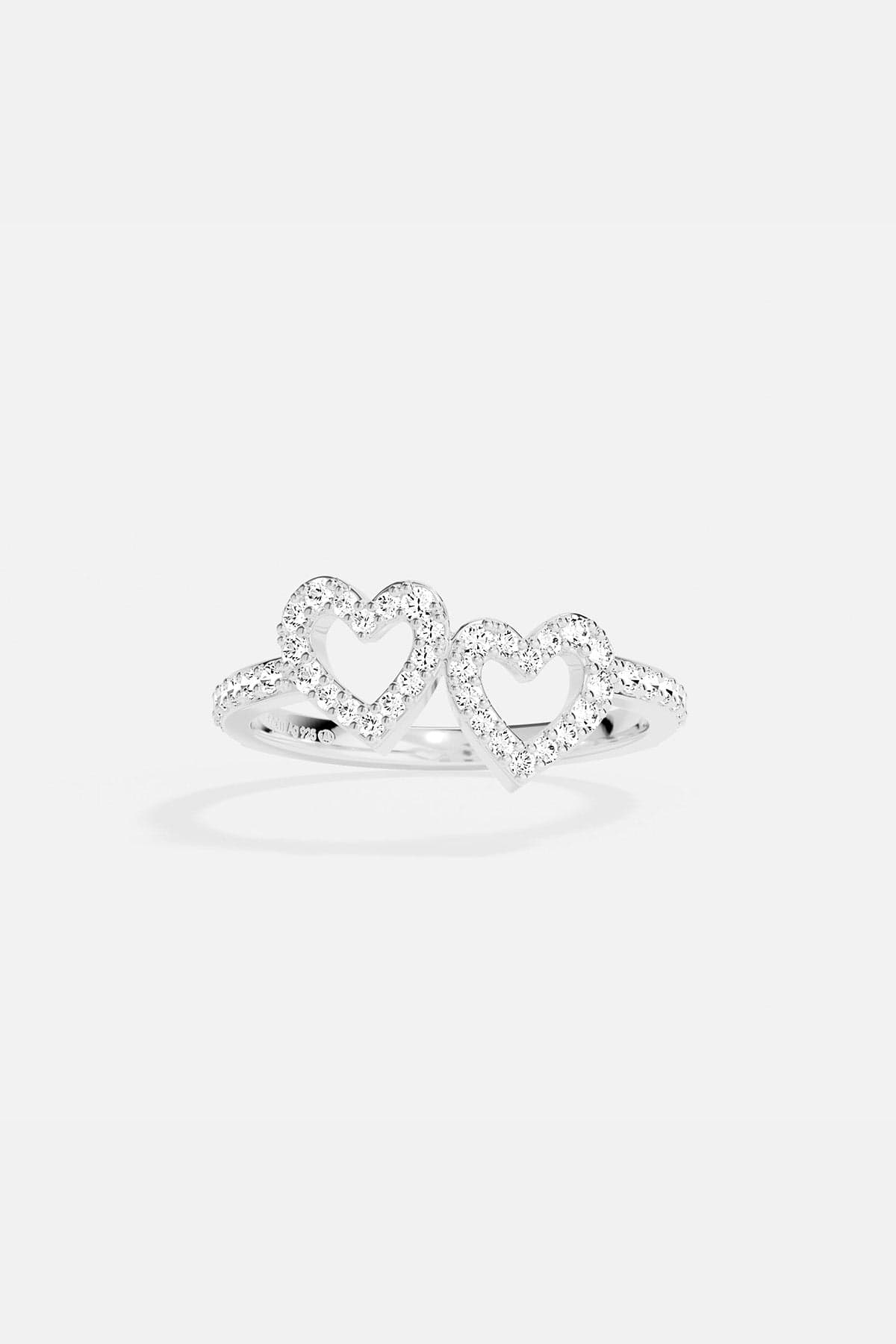 APM MONACO silver ring with two heart-shaped designs on a white background