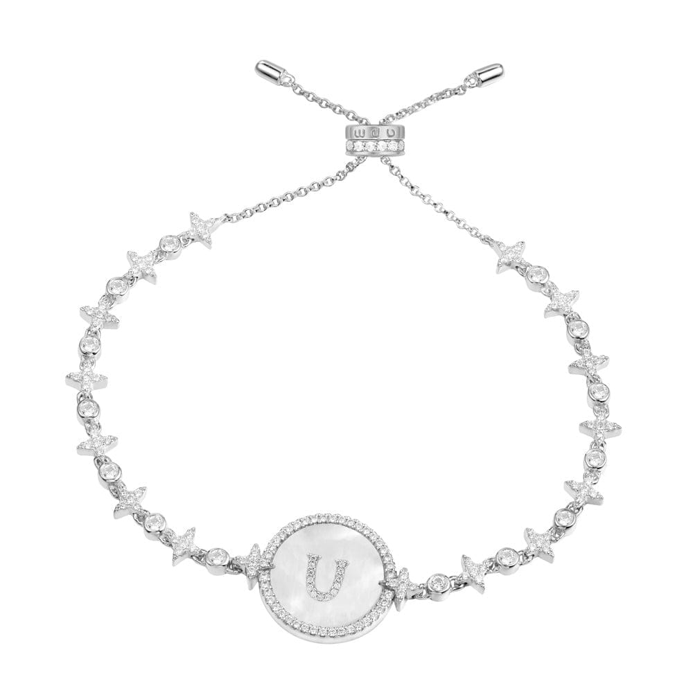 Bracelets APM Monaco: a chain bracelet with star and circle charms, featuring a central circular medallion framed with diamonds and an opaque glass center with the letter U.