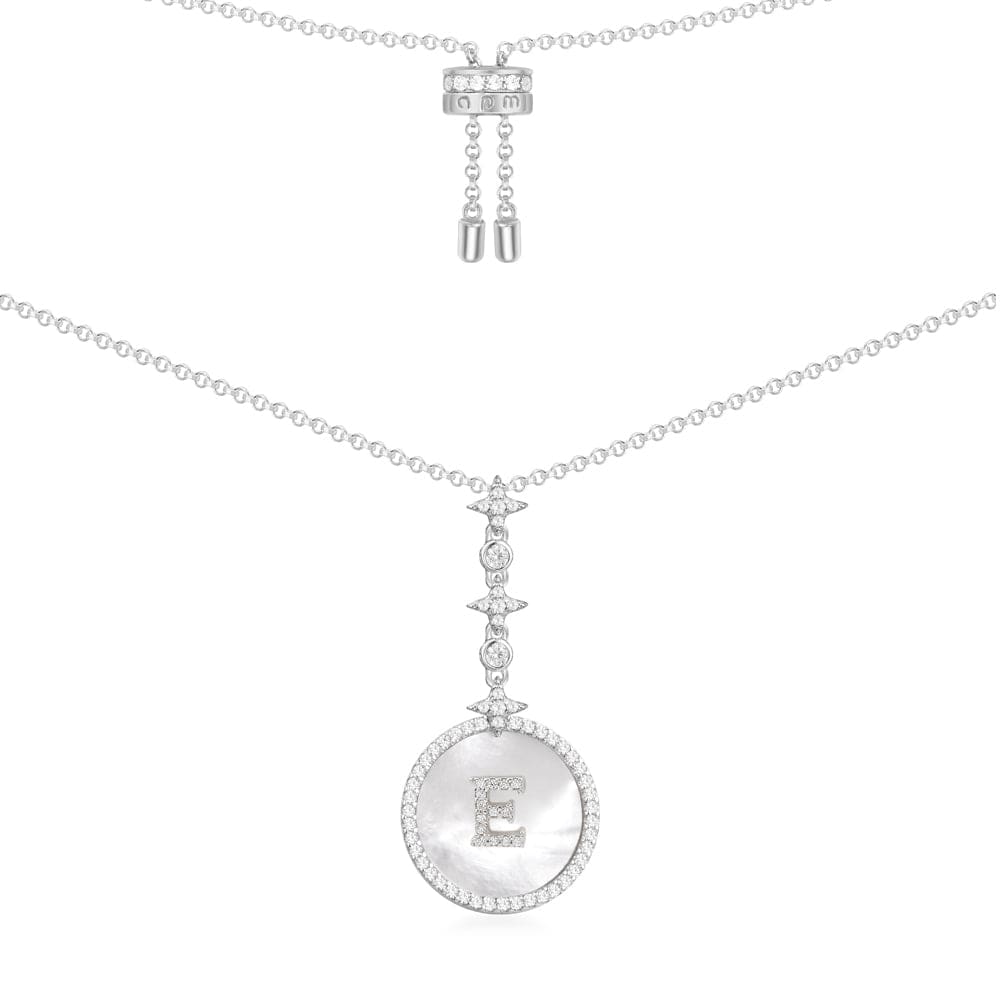 Necklaces APM Monaco. Round pendant of white mother-of-pearl with an E initial at the center on a thin silver chain.