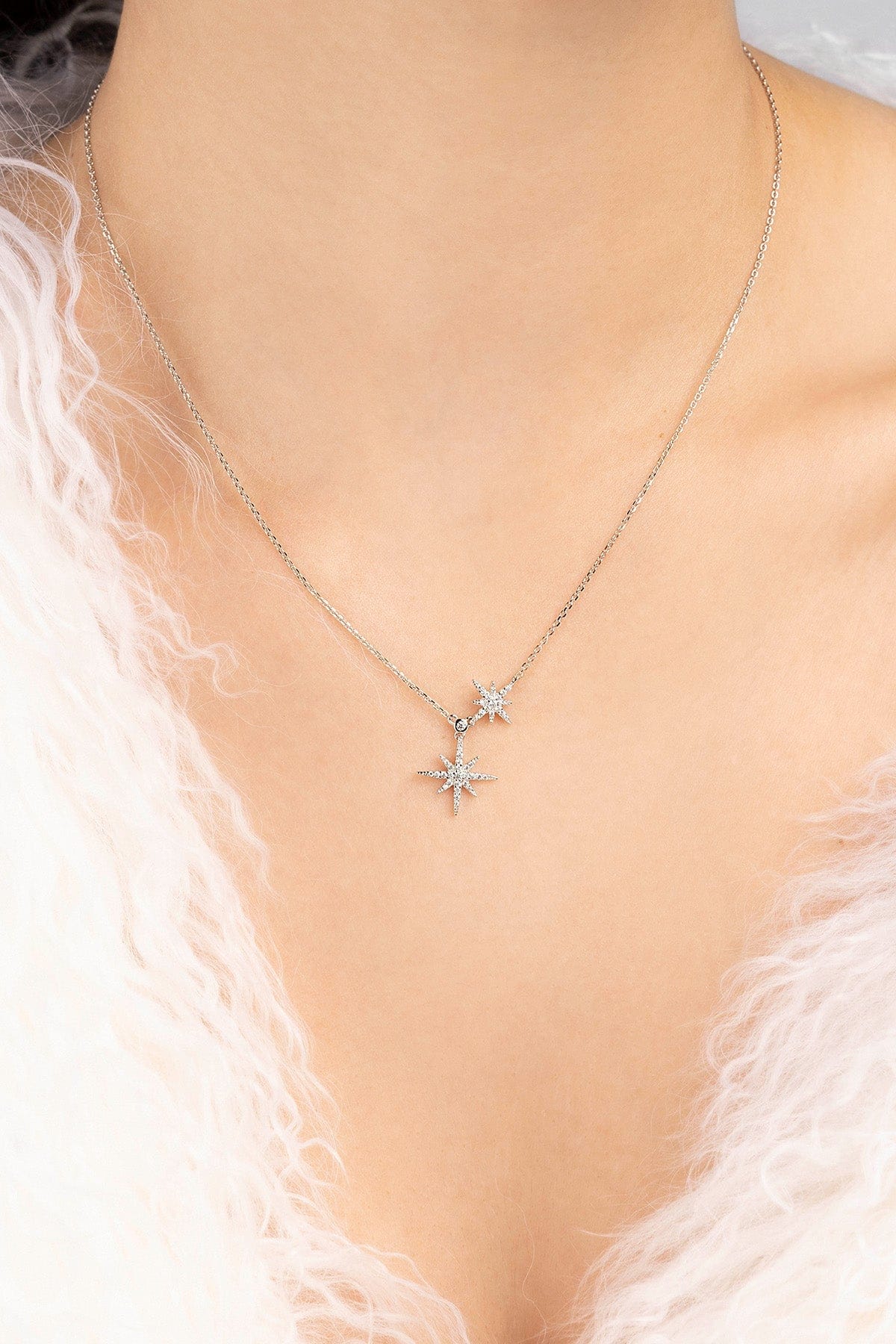 Necklace with star-shaped pendants on a model