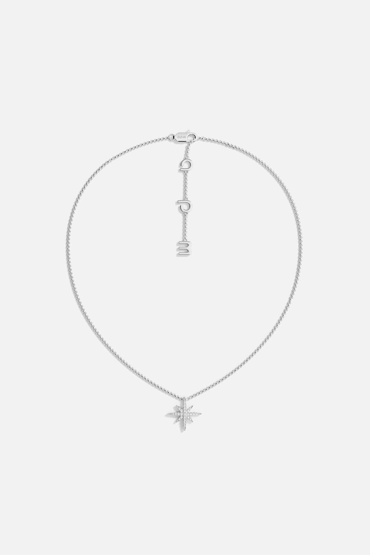 Necklaces APM Monaco, silver star-shaped pendant on a chain with meteorite texture.