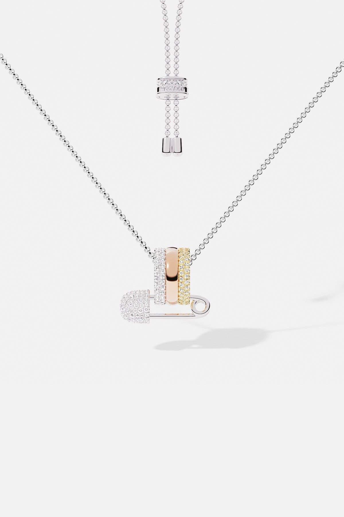 Necklaces APM Monaco multicolor diamond safety-pin pendant on an adjustable white-gold chain with stacked rings.