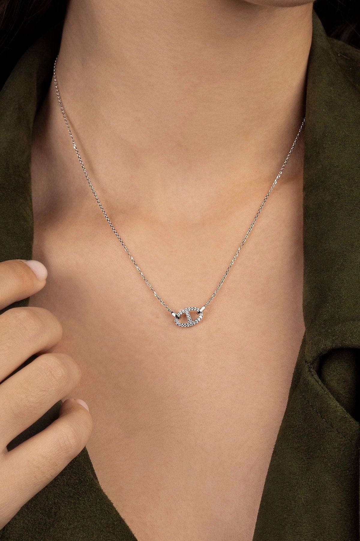 Necklaces APM Monaco, white silver-tone chain with an interlocking circle pendant encrusted with pavé stones.