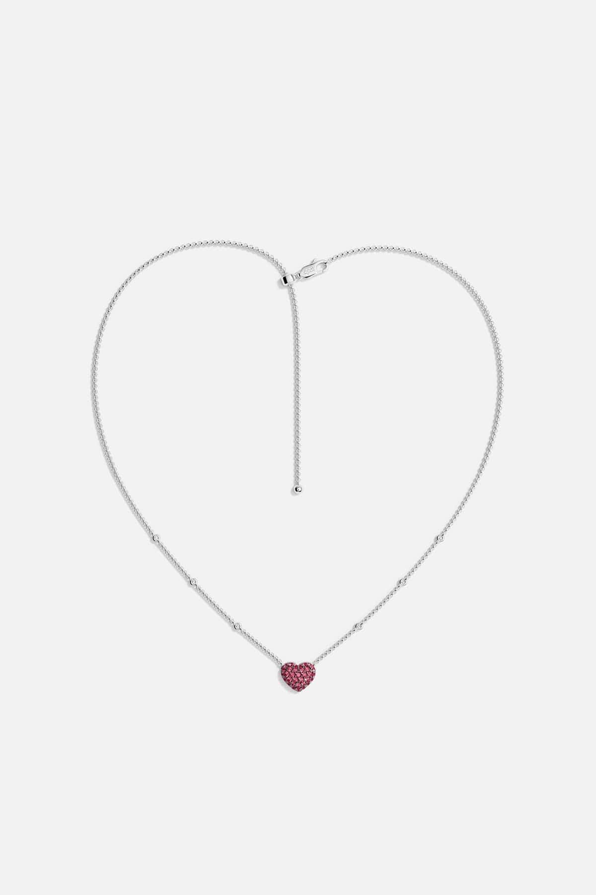 APM MONACO necklace with a heart-shaped fuchsia pendant on a white background
