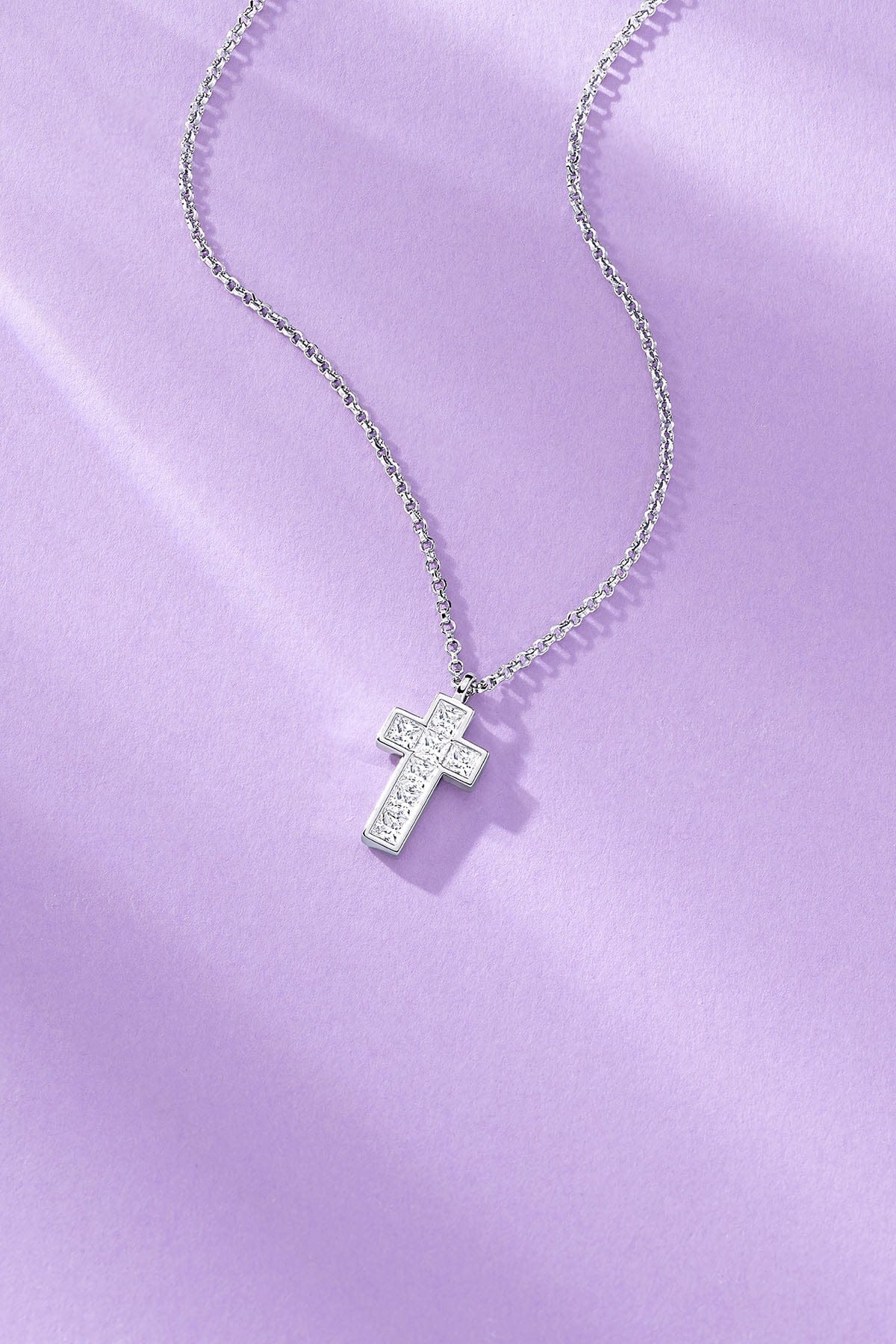 Lumière Pavé Cross Adjustable Necklace on a purple background