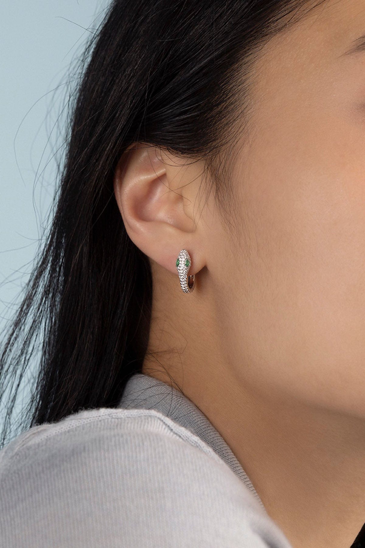 APM Monaco Kaa Hoop Earrings in silver worn on ear
