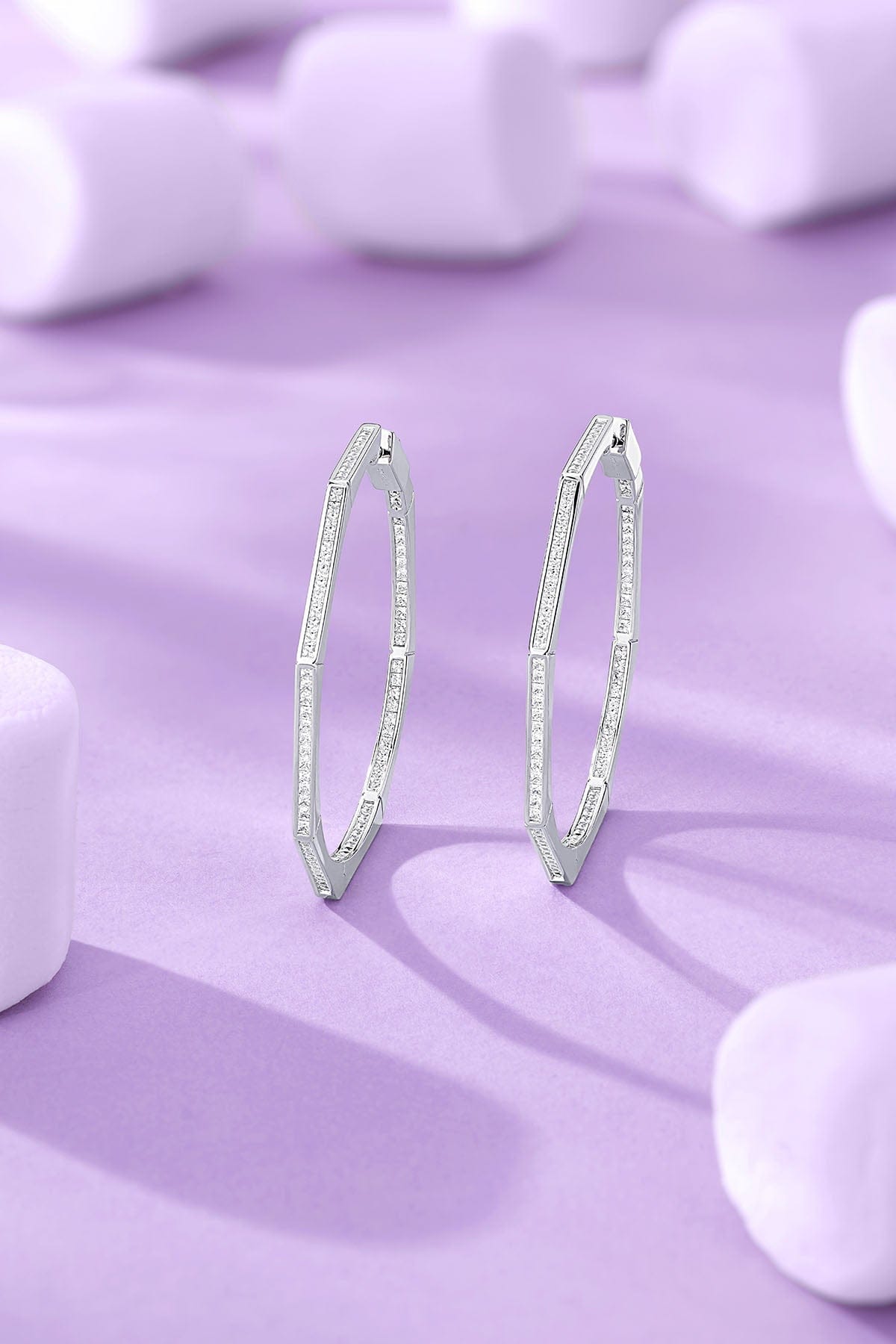 Geometric Pavé Hoop Earrings on a purple background