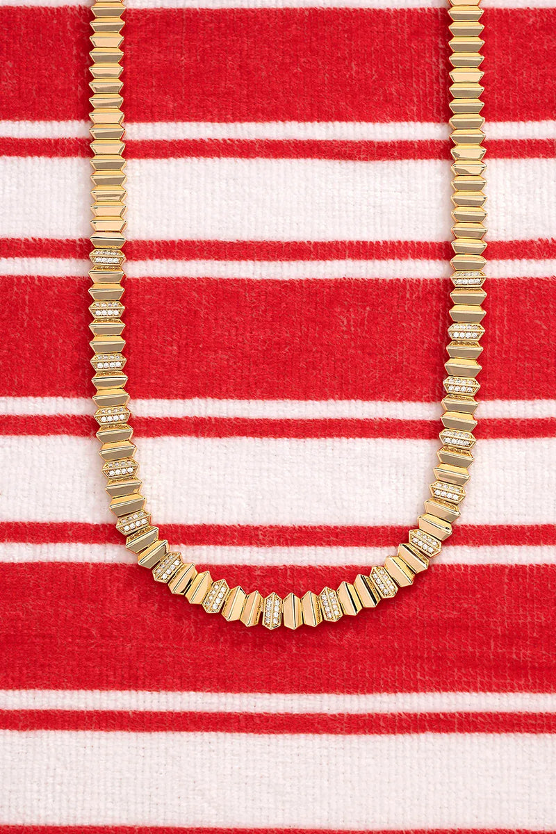 APM Monaco Yellow Up and Down Necklace on a red and white background
