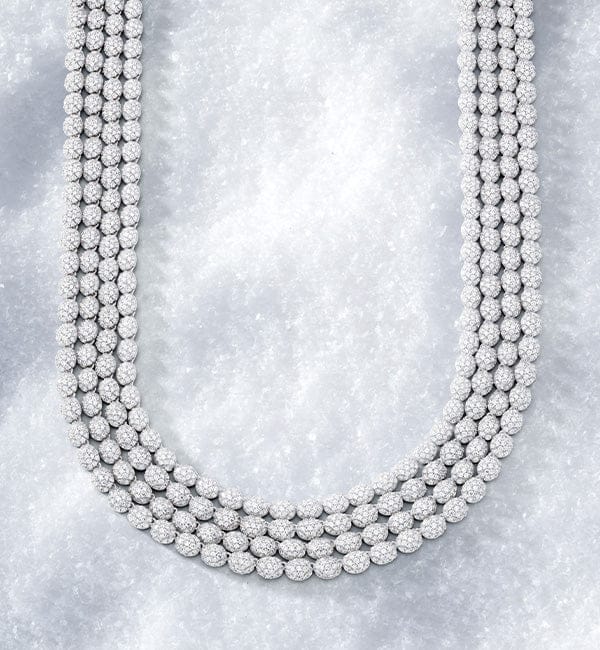 Multiple strands of APM MONACO hiver necklace on iced background