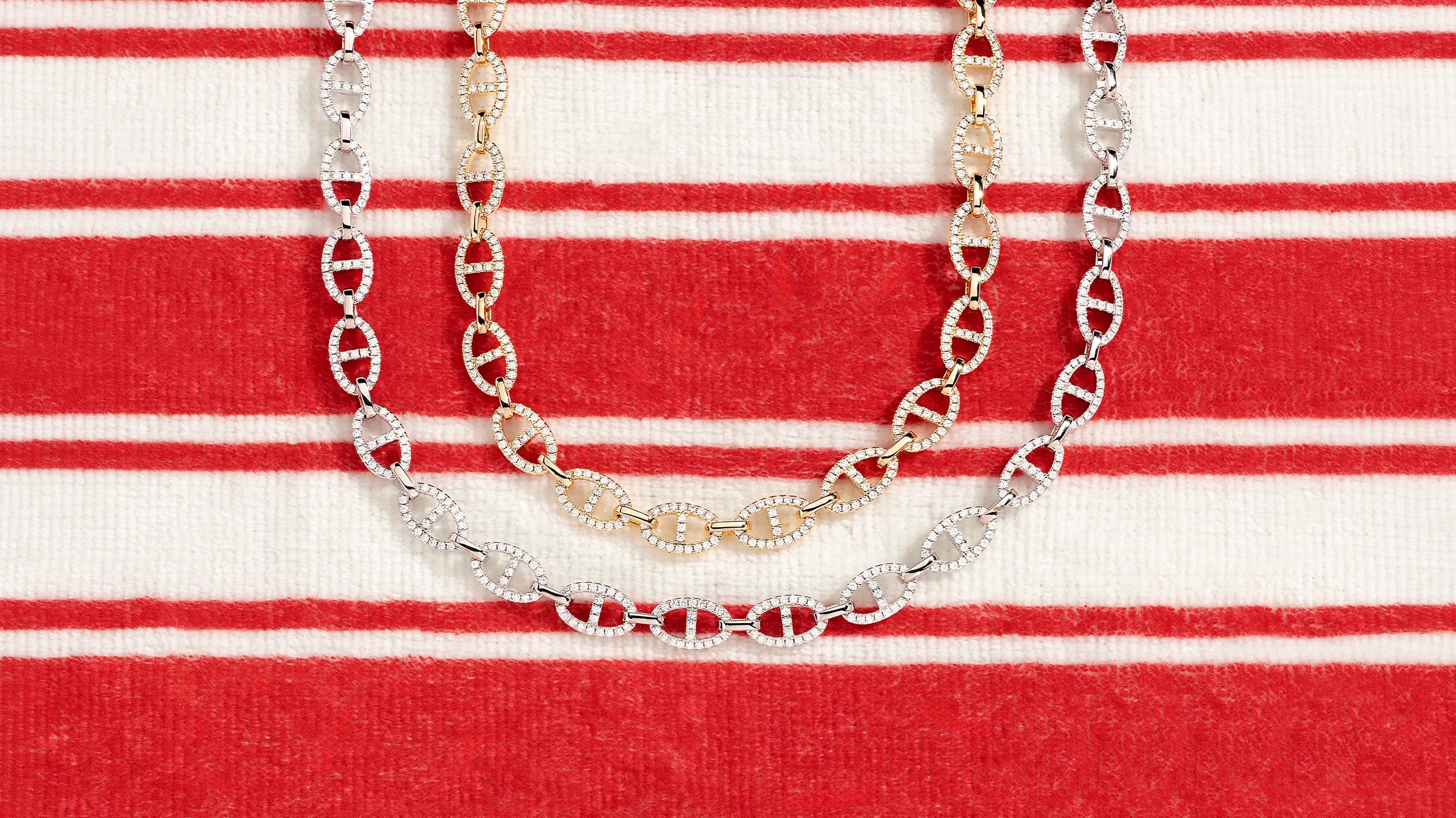 APM MONACO yacht club Necklace on a red and white striped fabric background