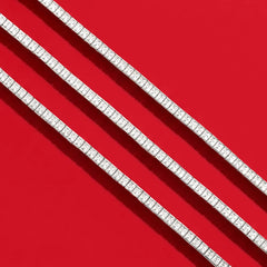 APM Monaco white tennis braceleton a red background