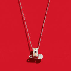 APM Monaco Morse Code Safety Pin Necklace on a red Background