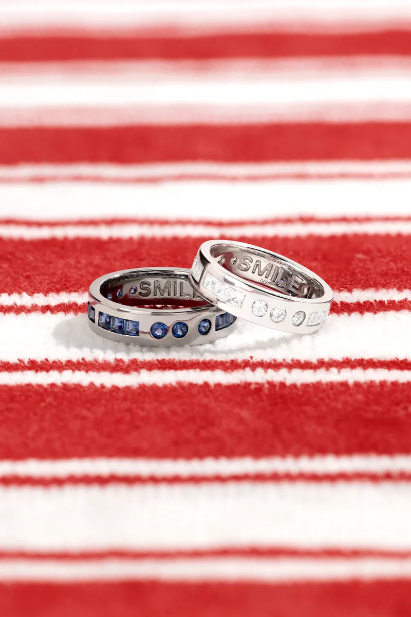APM Monaco White and Dark Grey morse rings on a red and whitebackground