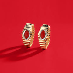 APM Monaco Yellow Les Calanques earrings on a red background
