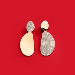 APM Monaco Yellow Soleil Earrings on a red background