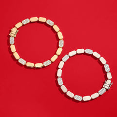 APM Monaco Yellow and White dainty bracelet on a red background