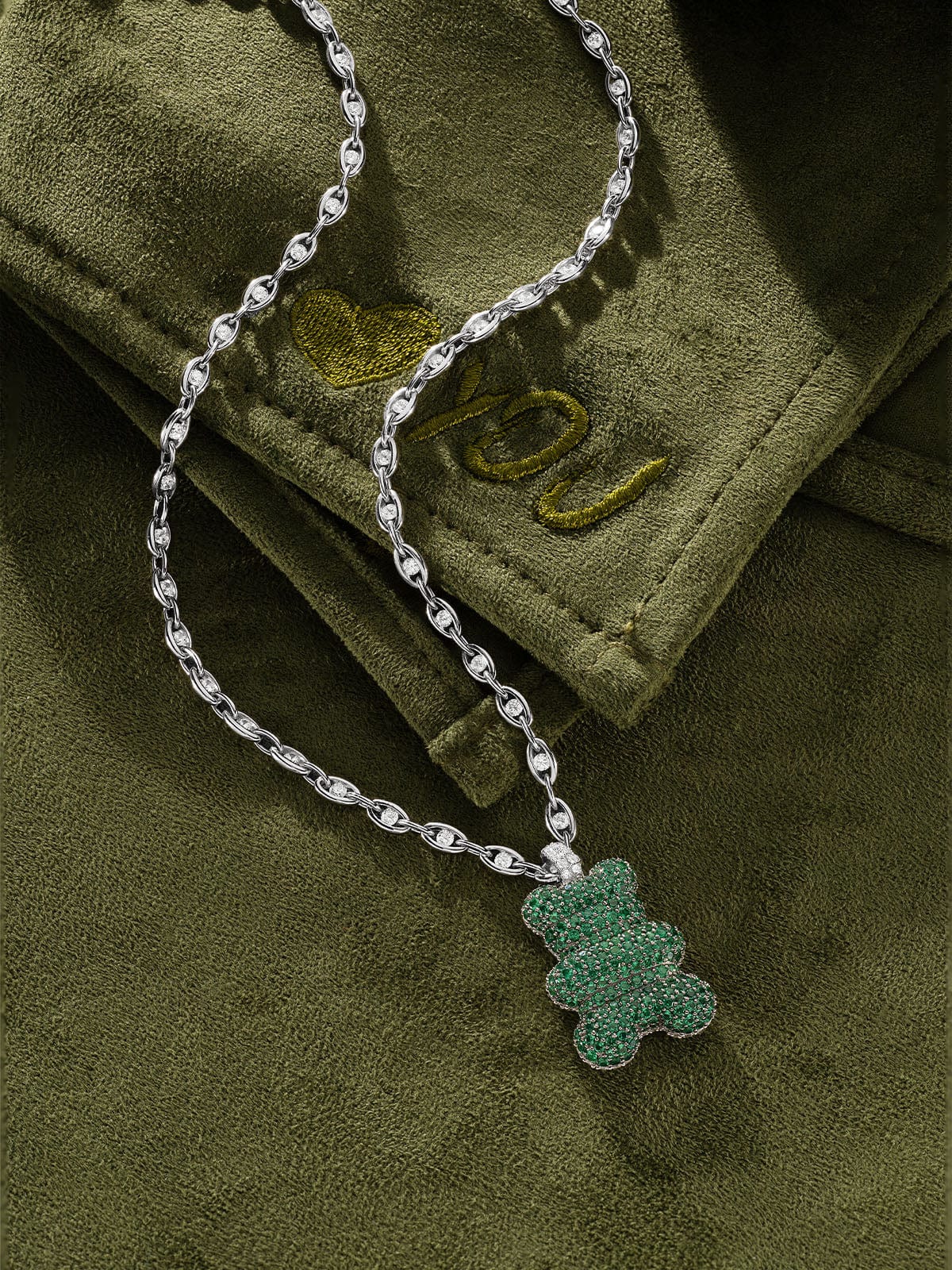 APM Monaco Collection Yummy Necklace on khaki suede leather background