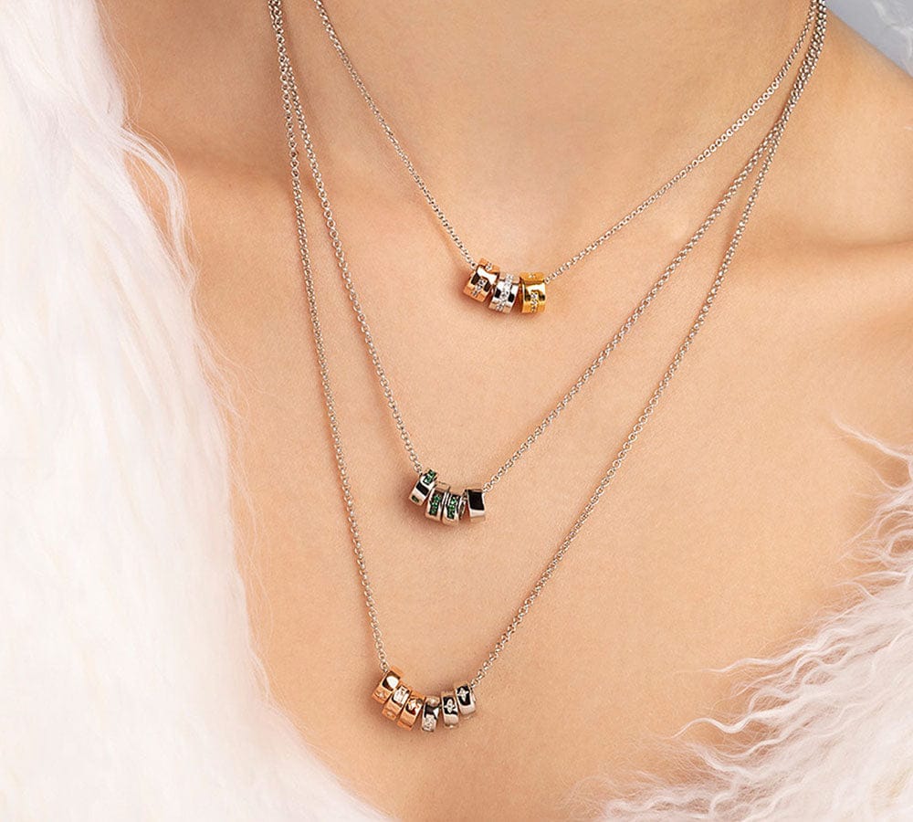 APM MONACO morse code necklaces on a soft white background