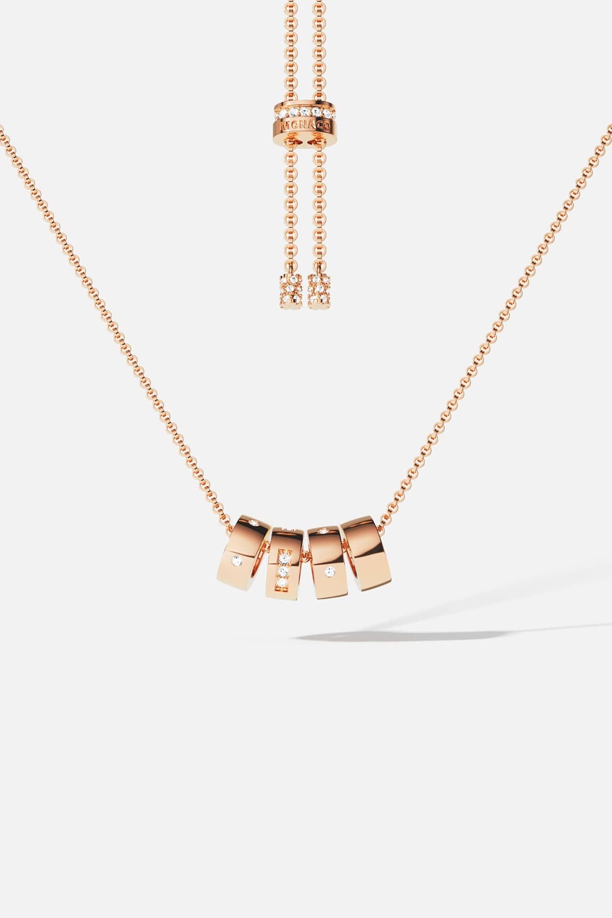 Necklaces APM Monaco: Rose gold adjustable necklace with square charms, some encrusted with crystals, suspended from a delicate chain.