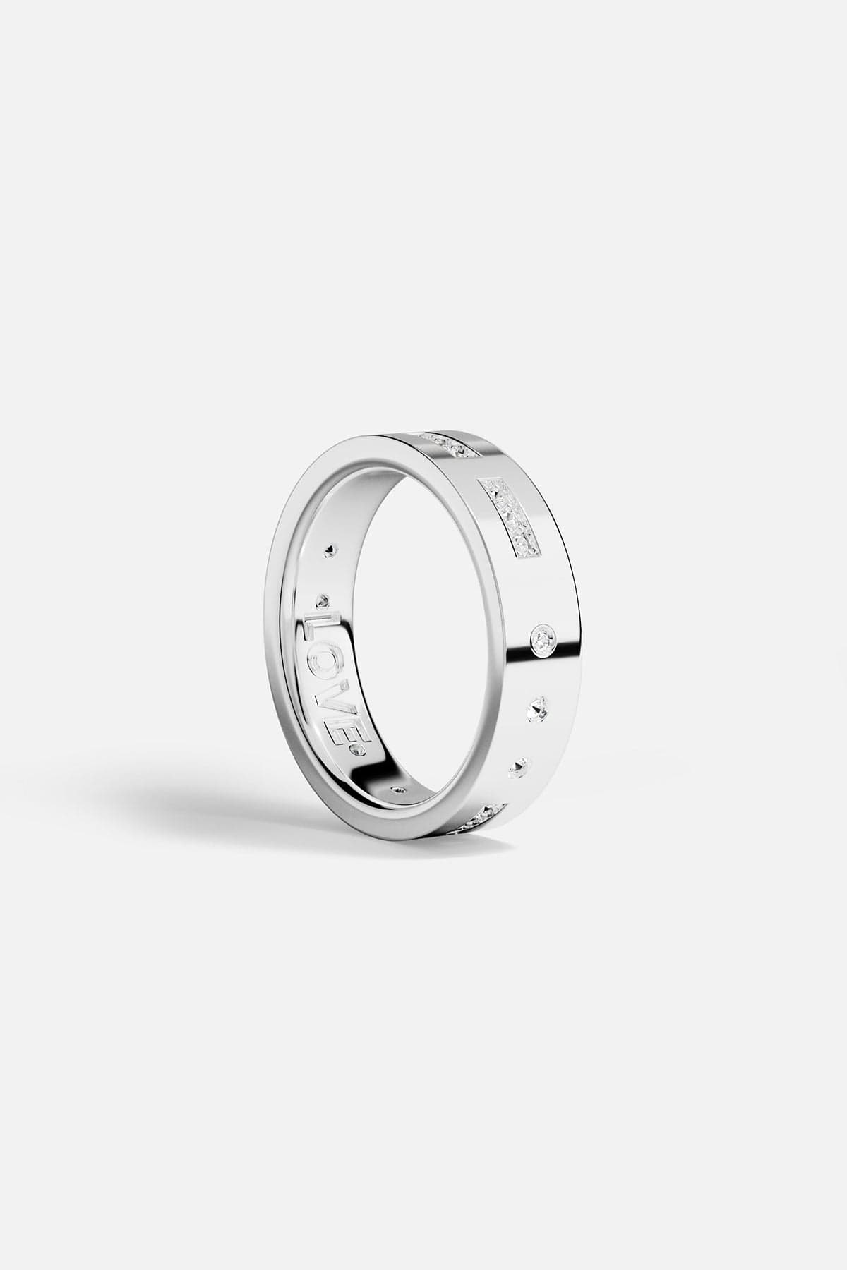 White alloy ring with engraved design on a white background