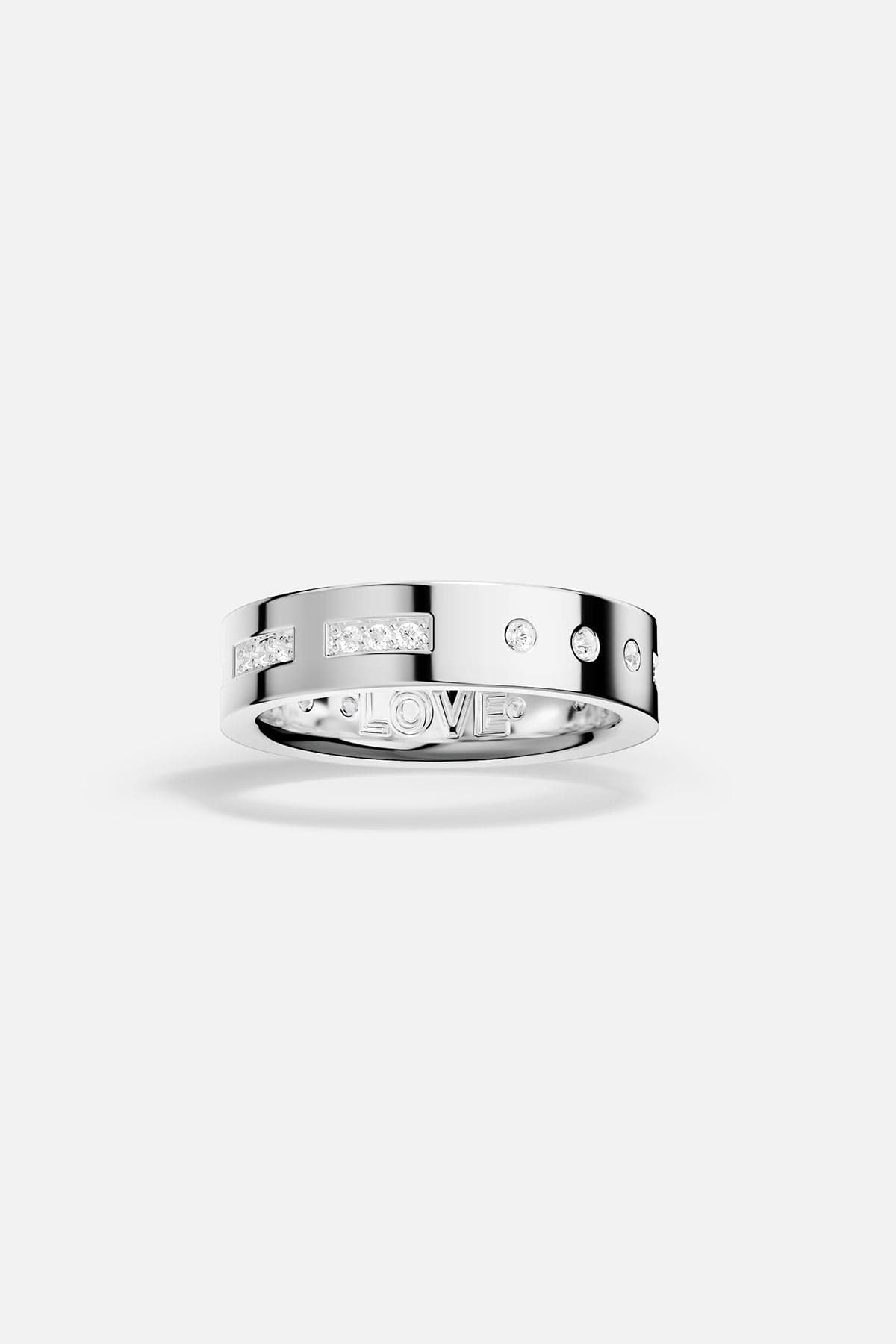 white alloy ring with embedded stones on a white background