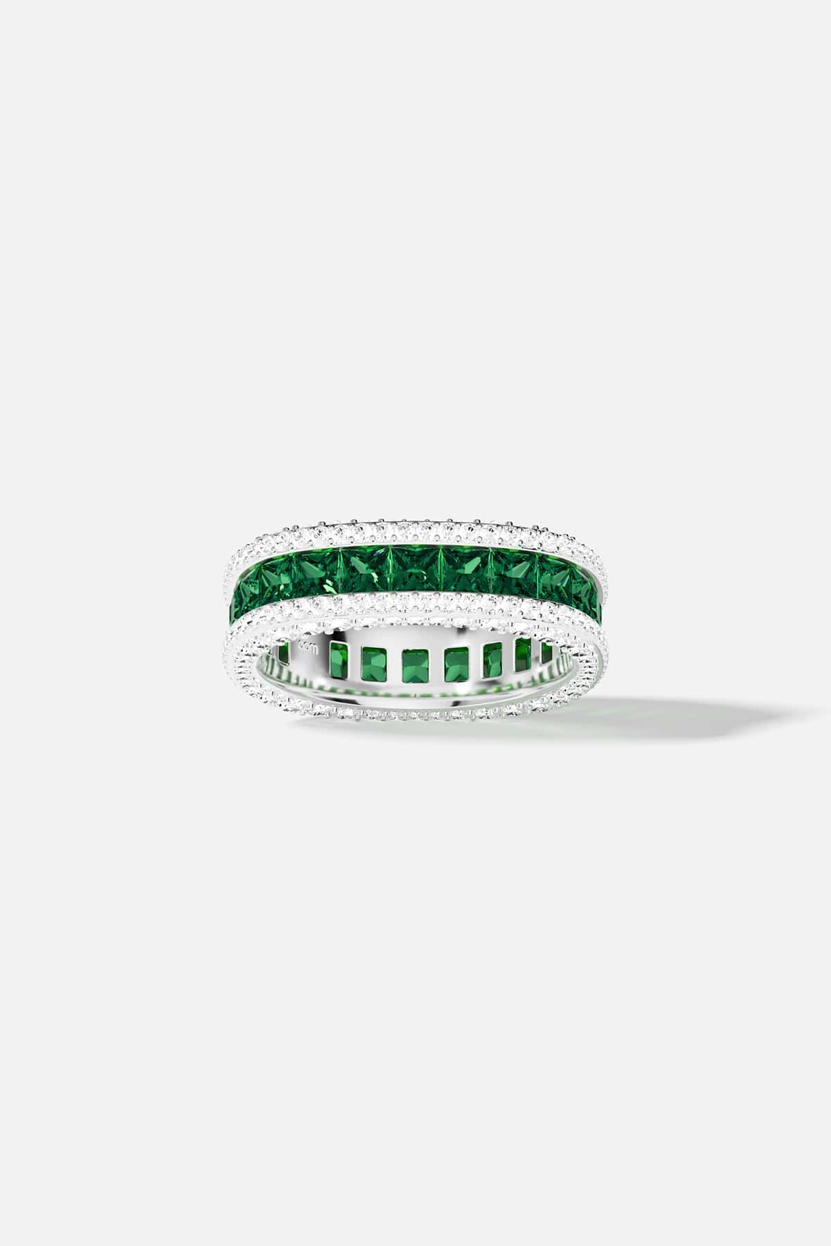white alloy ring with green and white stones on a white background