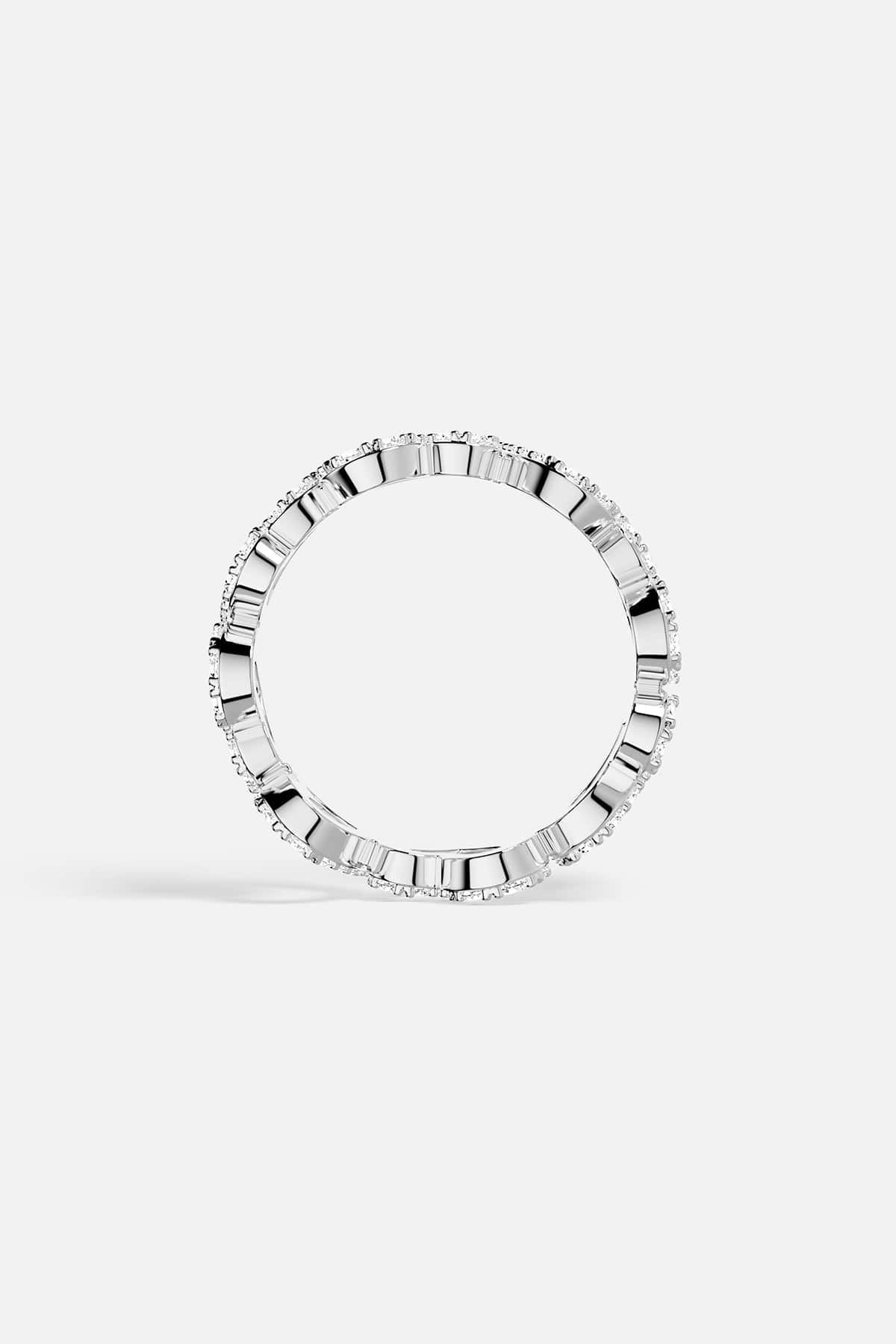 Silver ring with baguette-cut gemstones on a white background