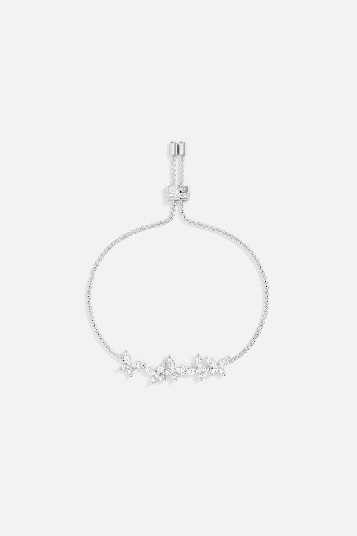 Silver necklace with butterfly design on a light gray background