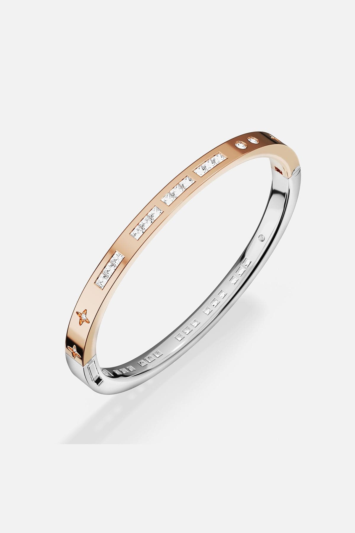 Two-toned ring with diamond accents on a white background