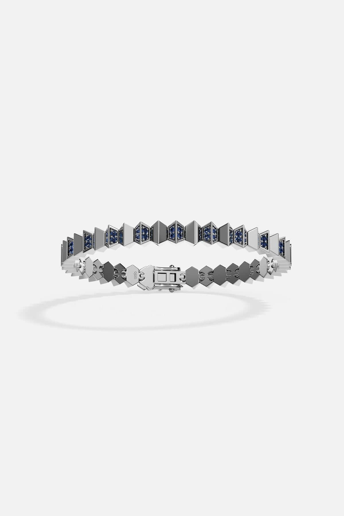Silver bracelet with blue gemstones on a white background