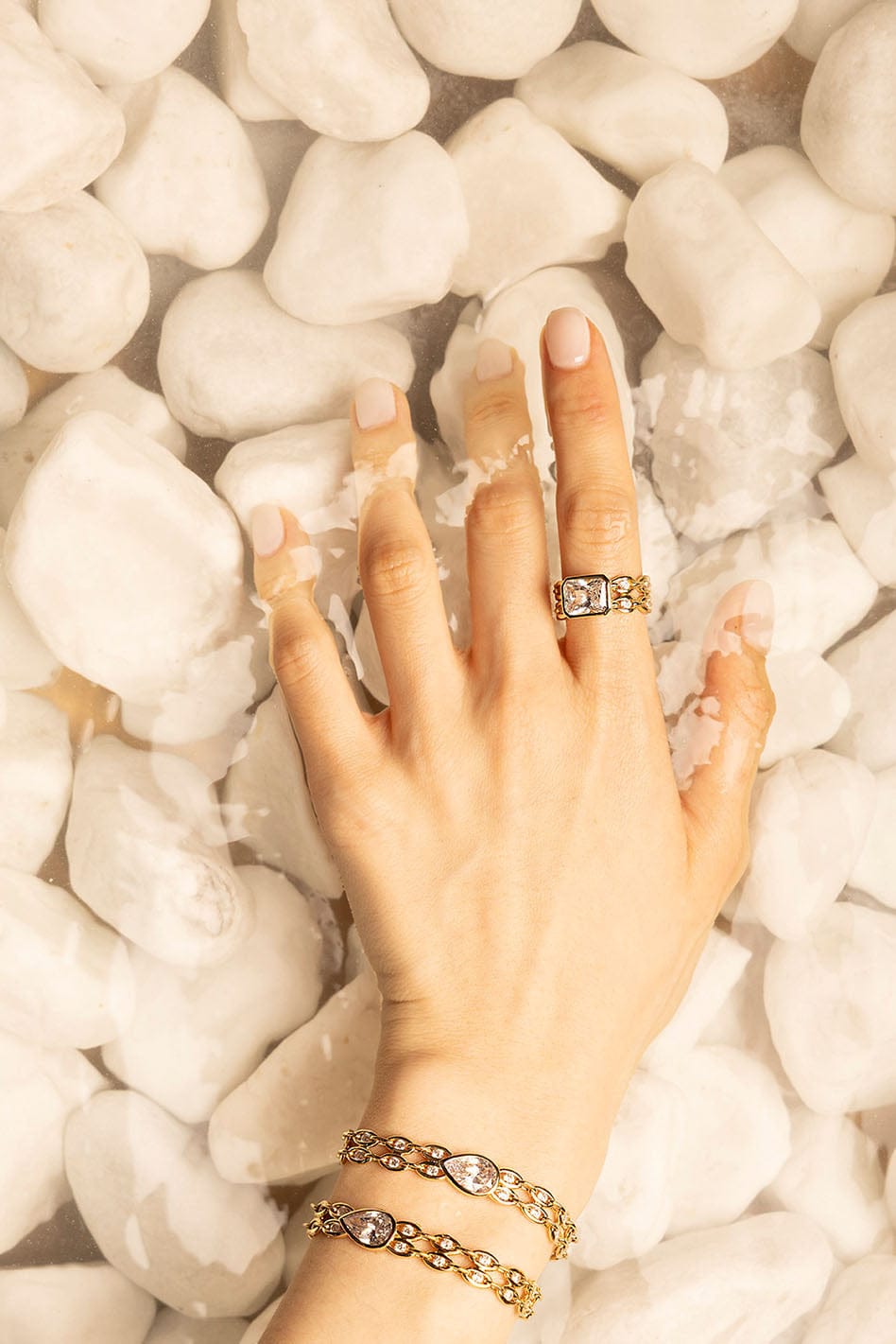 Rings, APM Monaco. Yellow gold statement ring with white diamonds; matching chain bracelet in yellow gold.
