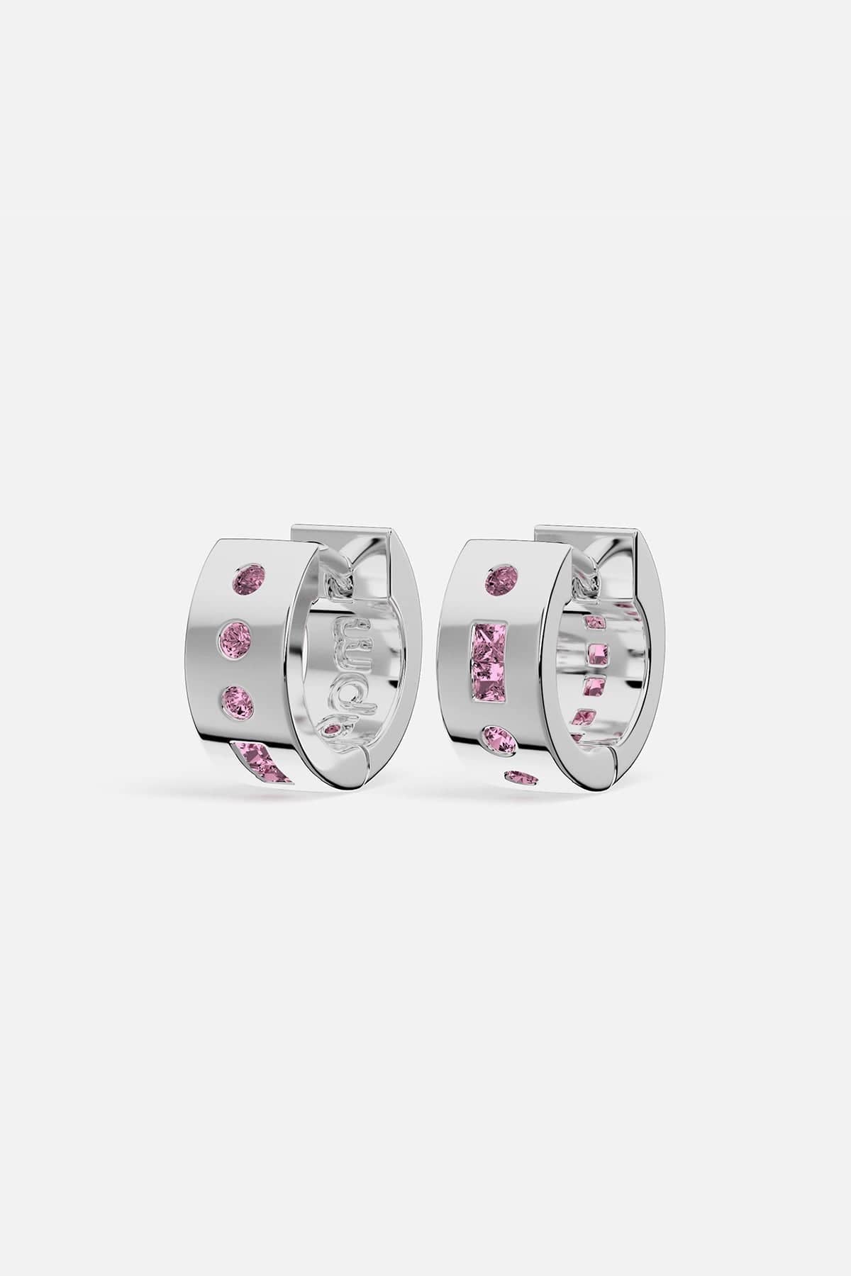 Silver hoop earrings with pink gemstones on a white background